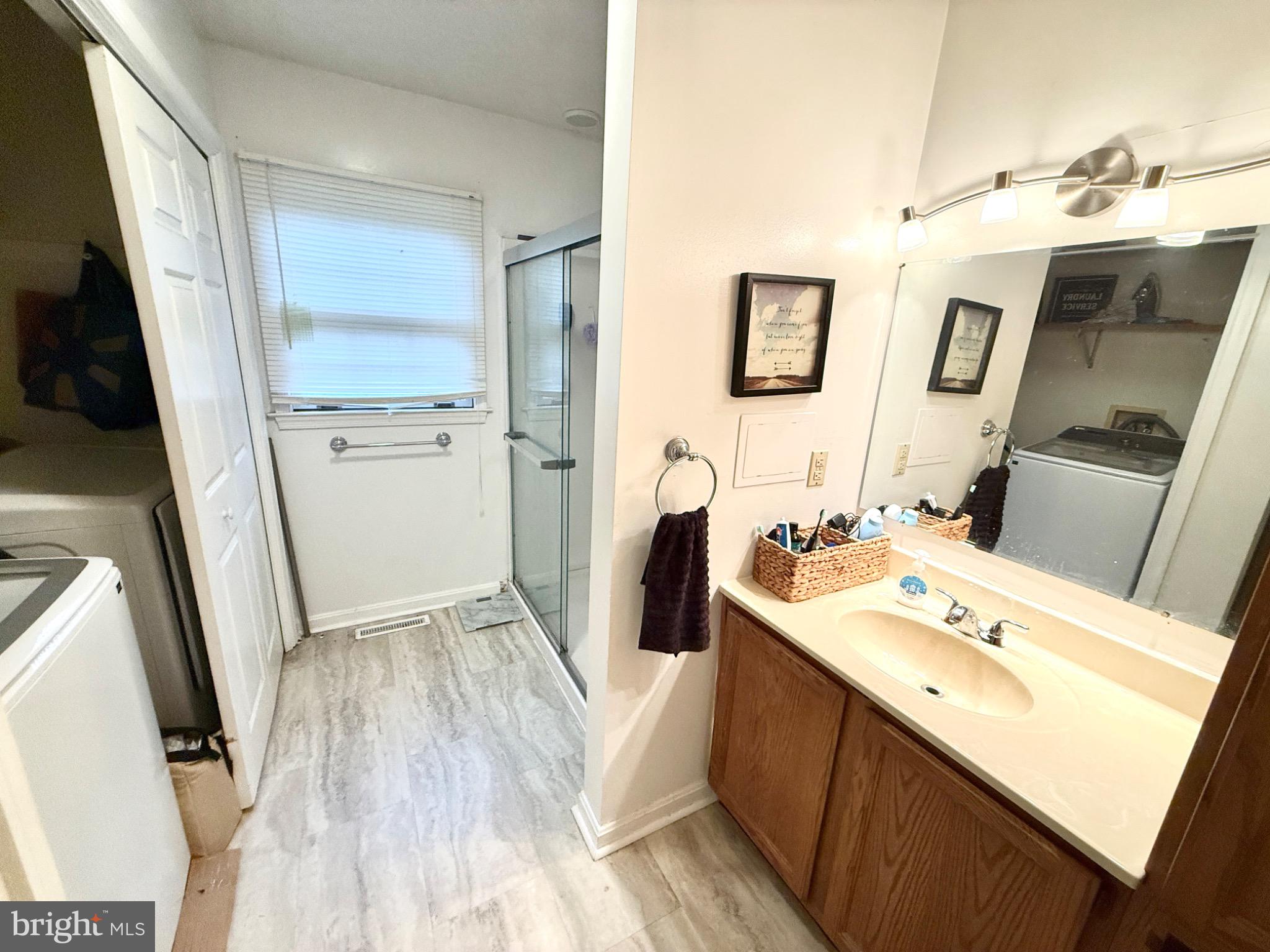 30772 River Road Laurel, DE 19956 - Photo 9 of 21 a bathroom with a sink a mirror and a shower