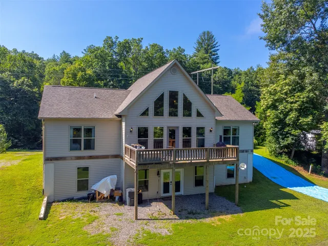 a front view of a house with swimming pool and sitting area