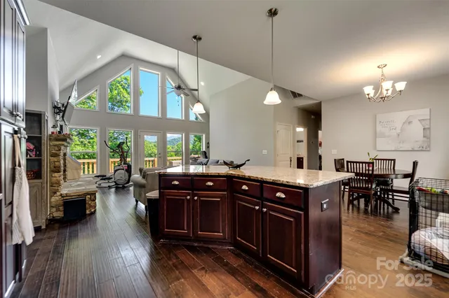 a living room with furniture large window and a fireplace