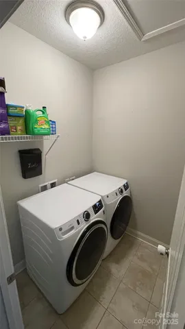 a bed room with a bed and a chandelier