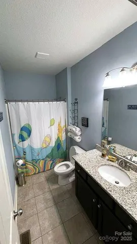 a bed room with a bed and a chair