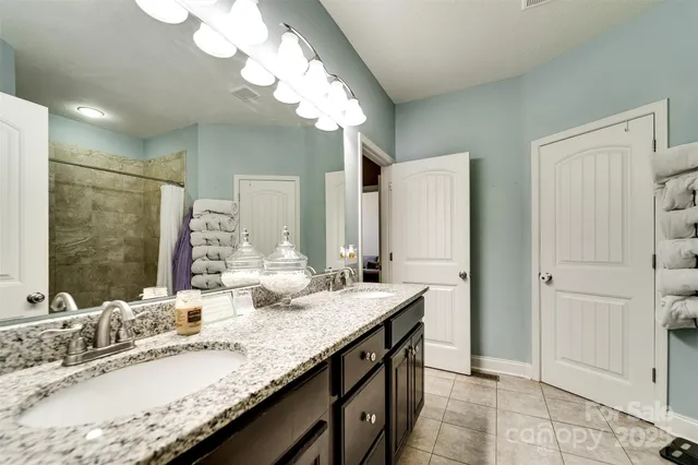 a bedroom with a bed and flat screen tv