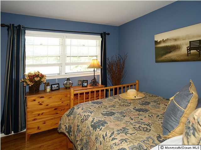 14 Crest Road Middletown, NJ 07748 - Photo 15 of 25 a bedroom with a bed and wooden floor