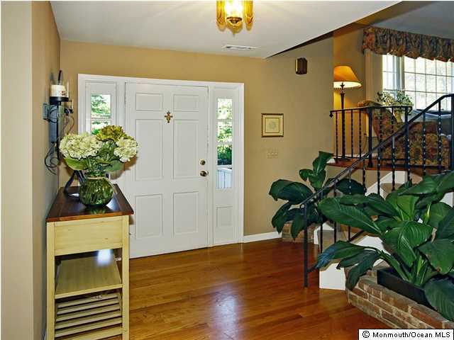 14 Crest Road Middletown, NJ 07748 - Photo 2 of 25 a vase of flowers sitting on a wooden floor