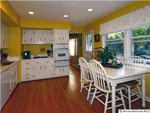 14 Crest Road Middletown, NJ 07748 - Photo 7 of 25 a kitchen with stainless steel appliances kitchen island granite countertop a table chairs and a refrigerator