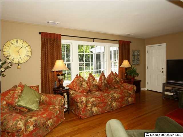 14 Crest Road Middletown, NJ 07748 - Photo 8 of 25 a living room with furniture large window and a flat screen tv