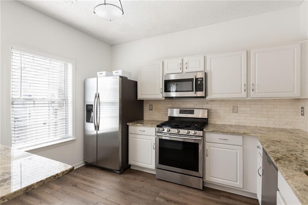 5750 Reps Trace Norcross, GA 30071 - Photo 8 of 18 a kitchen with stainless steel appliances granite countertop a stove a refrigerator and a microwave