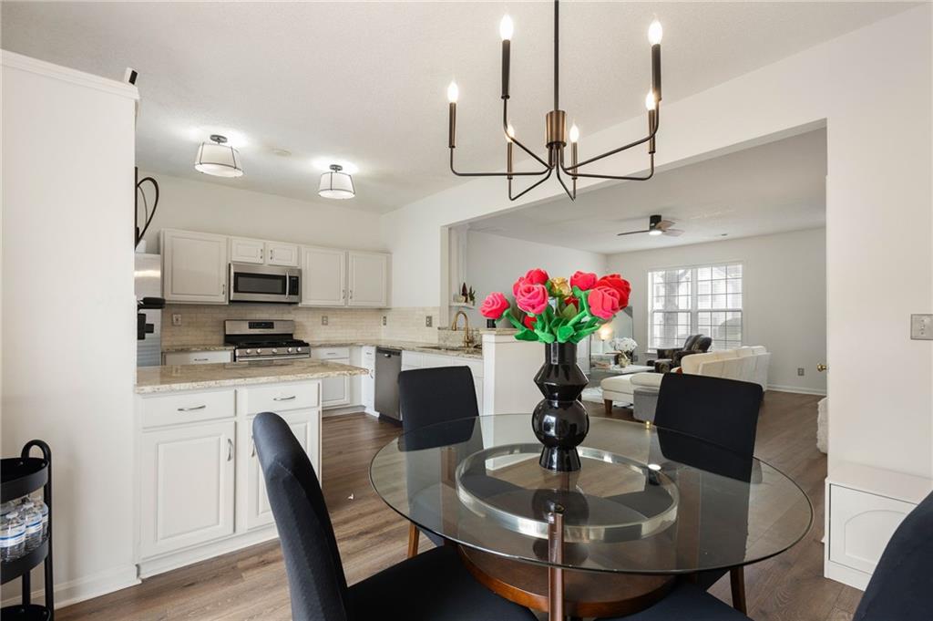 5750 Reps Trace Norcross, GA 30071 - Photo 9 of 18 a dining room with furniture a potted plant and kitchen view