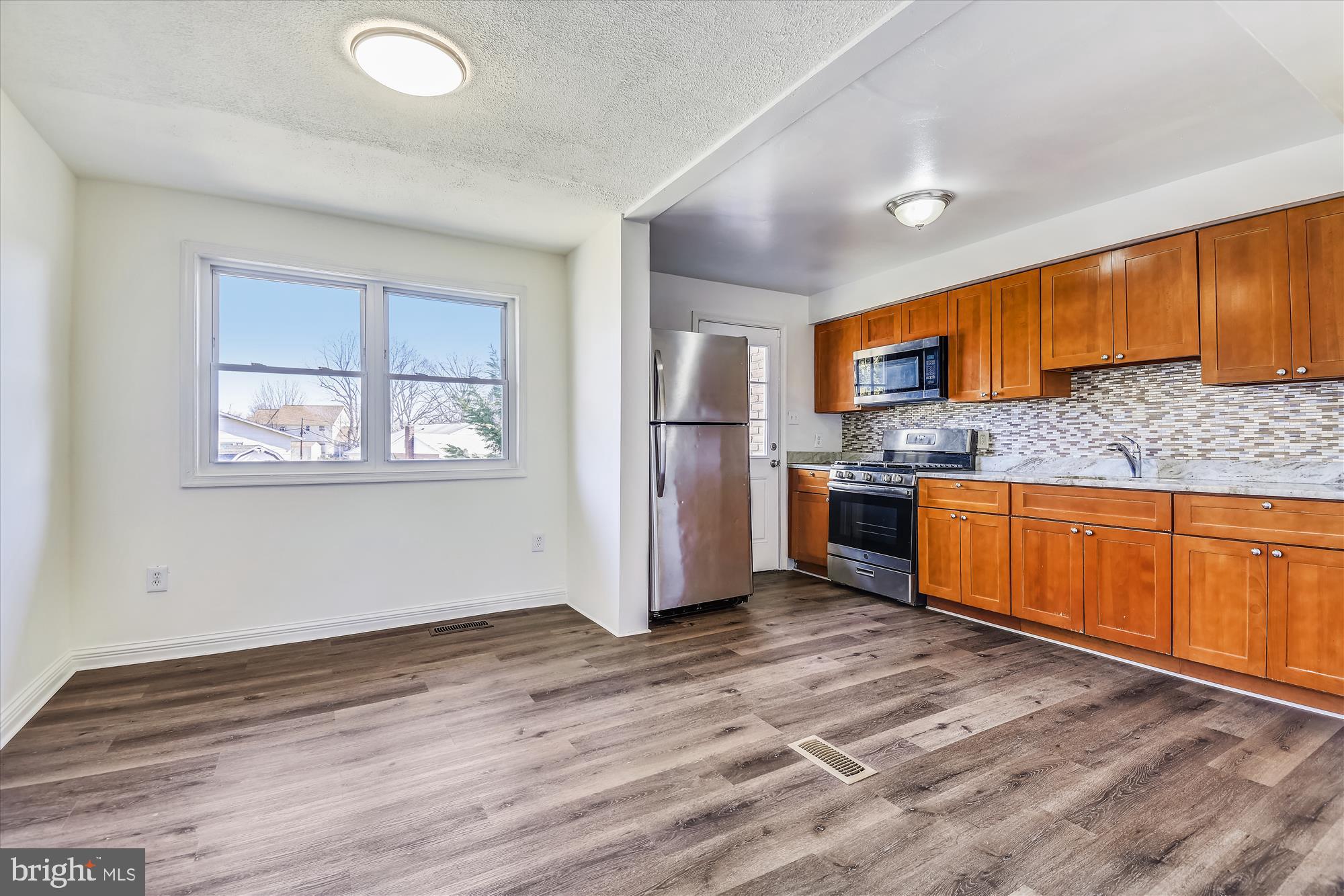 621 Kingston Road Middle River, MD 21220 - Photo 6 of 26 a kitchen with stainless steel appliances granite countertop a stove a refrigerator and a sink