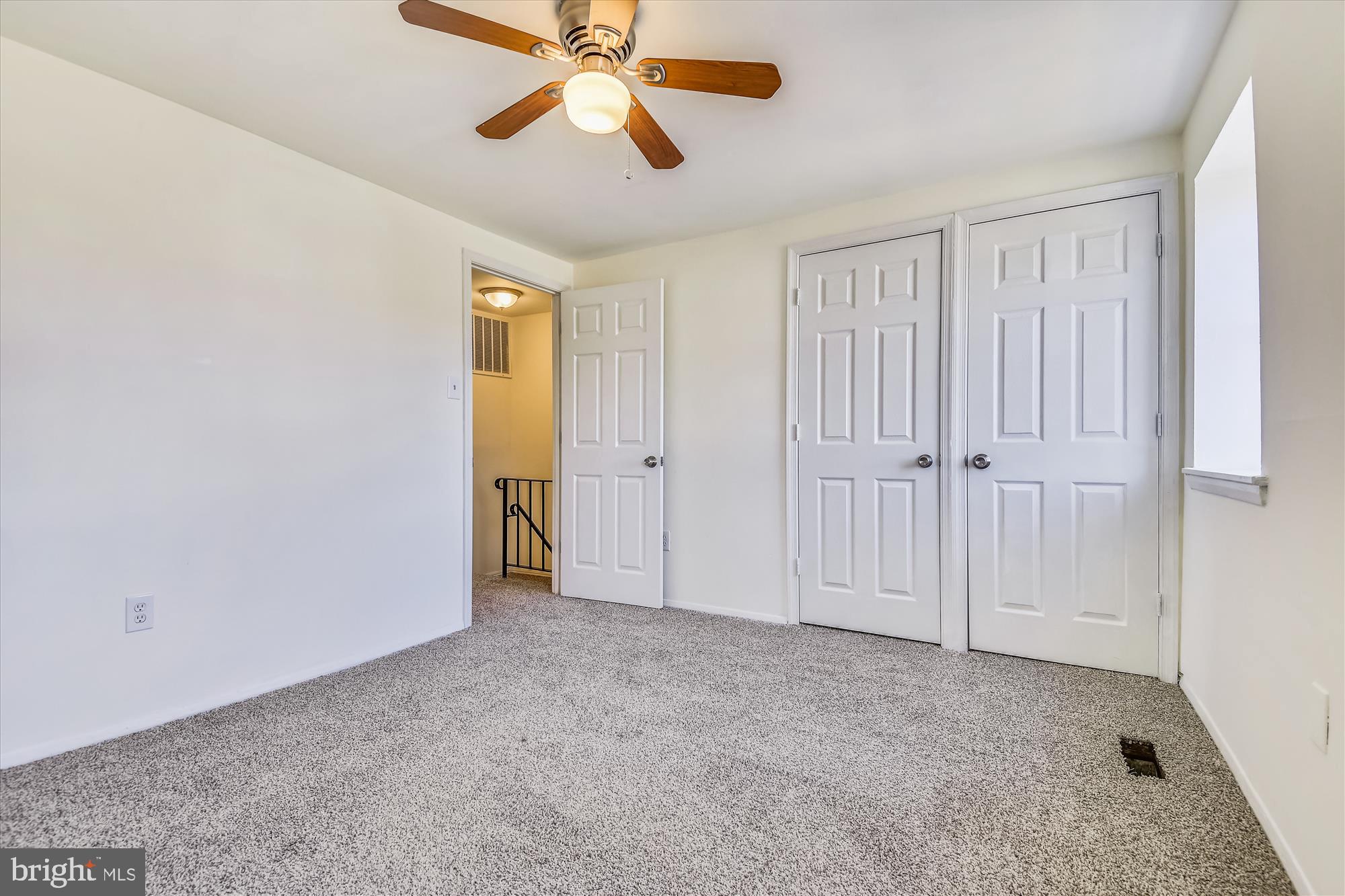 621 Kingston Road Middle River, MD 21220 - Photo 9 of 26 an empty room with closet and a chandelier fan