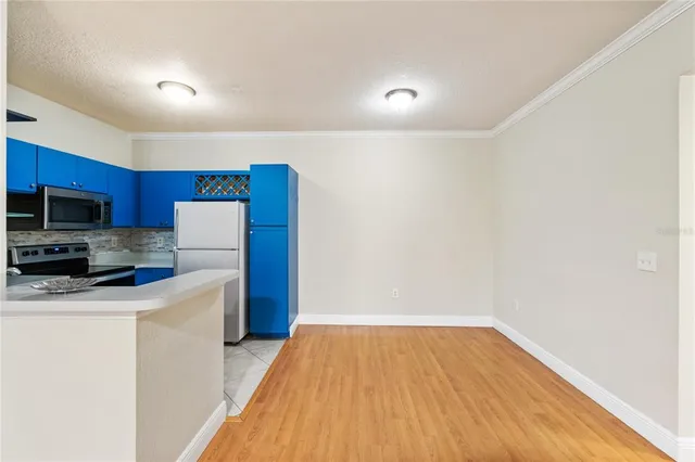 a view of a kitchen with a sink and a refrigerator