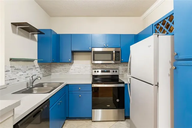 a kitchen with a refrigerator sink and microwave