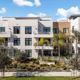 a view of multiple house with a yard and potted plants