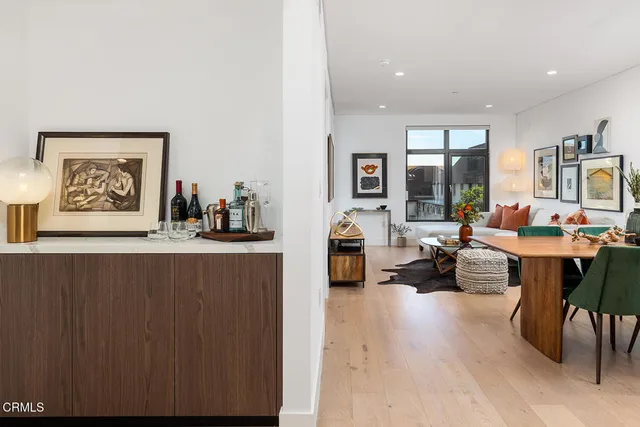 a living room with furniture and a large mirror