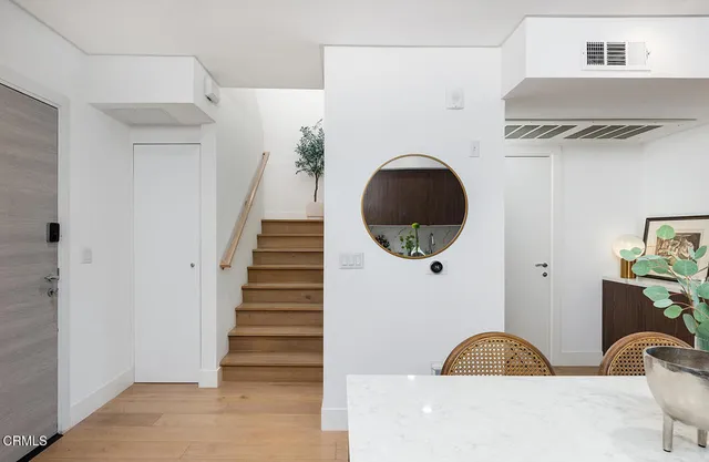 a view of a livingroom with wooden floor and a large window