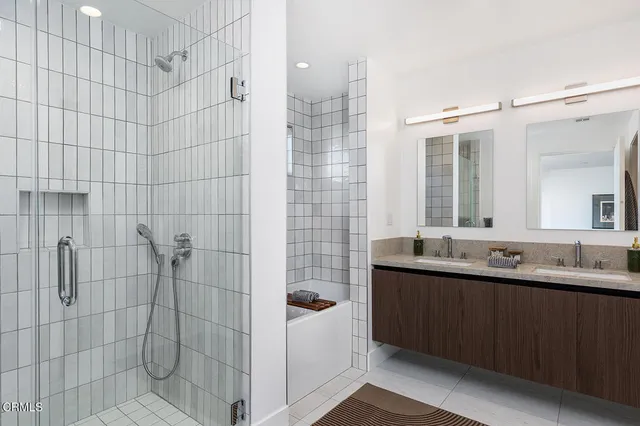 a bathroom with a double vanity sink and mirror