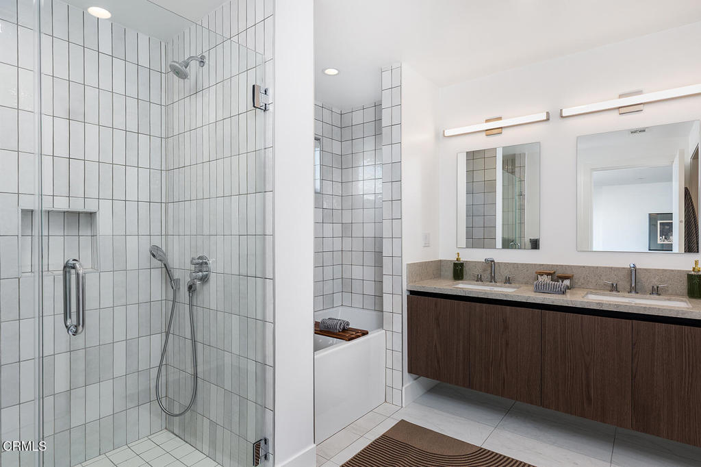 399 East Del Mar Boulevard, Unit 308 Pasadena, CA 91101 - Photo 20 of 32 a bathroom with a double vanity sink and mirror