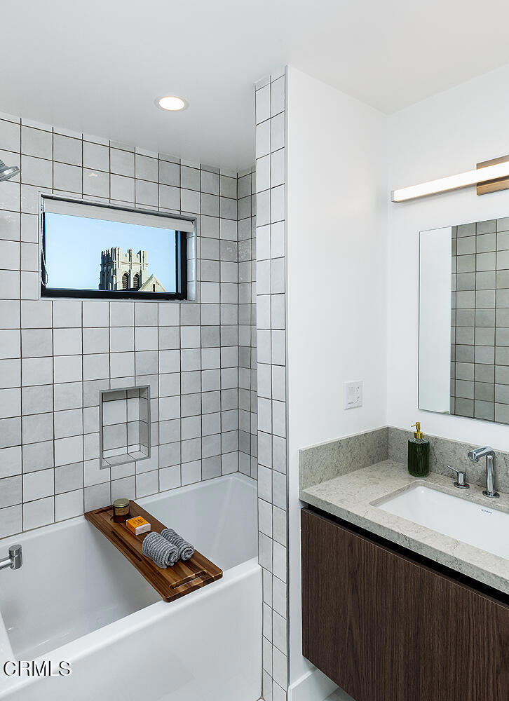 399 East Del Mar Boulevard, Unit 308 Pasadena, CA 91101 - Photo 21 of 32 a bathroom with a tub sink and mirror
