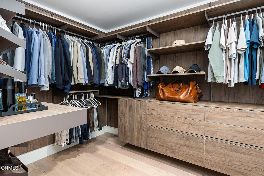 399 East Del Mar Boulevard, Unit 308 Pasadena, CA 91101 - Photo 22 of 32 a view of walk in closet with clothes and shoes