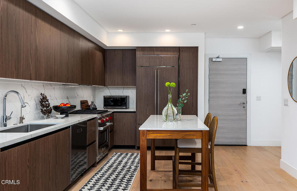 399 East Del Mar Boulevard, Unit 308 Pasadena, CA 91101 - Photo 3 of 32 a kitchen with a sink cabinets and appliances
