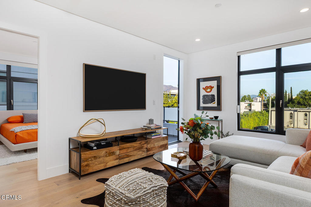 399 East Del Mar Boulevard, Unit 308 Pasadena, CA 91101 - Photo 8 of 32 a living room with furniture and a flat screen tv