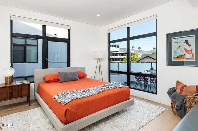a bedroom with a large bed and a window