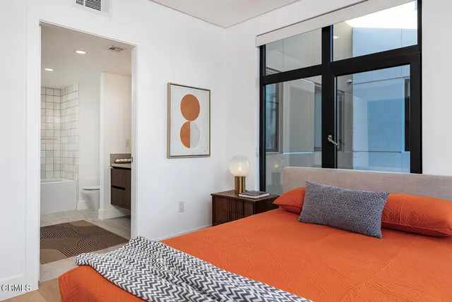 a bedroom with a bed and a mirror