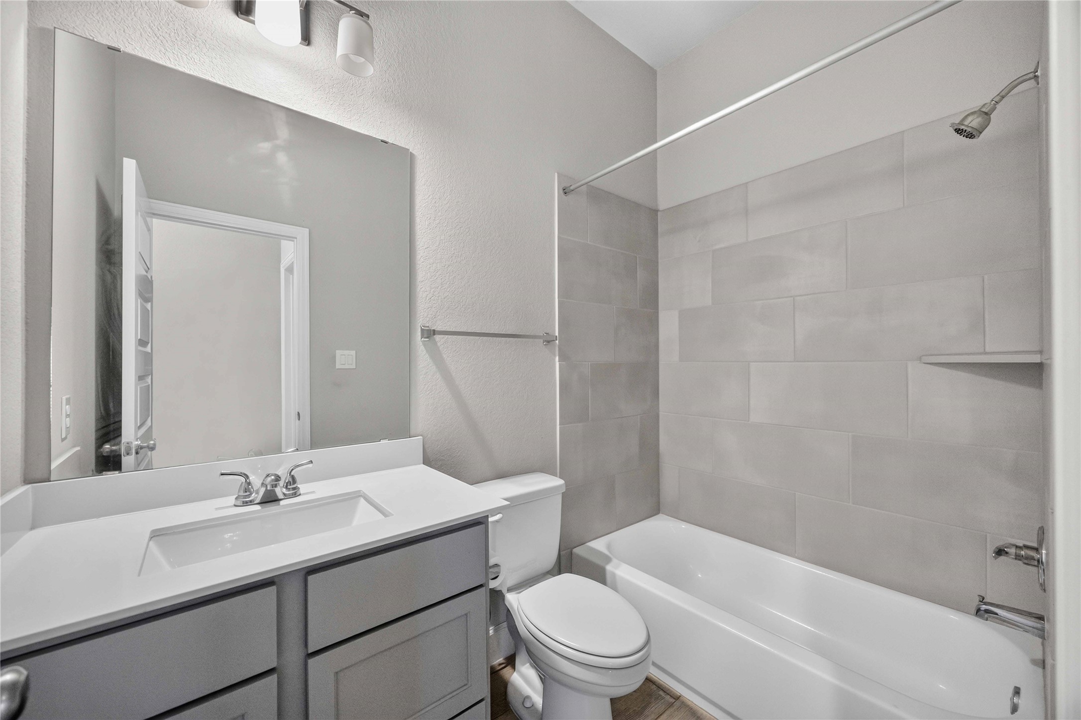 4333 Arbor Crest Lane Manvel, TX 77578 - Photo 25 of 40 Consistently styled with the home's modern aesthetic, this secondary bath features a crisp vanity and a clean tile-surround tub-shower setup.