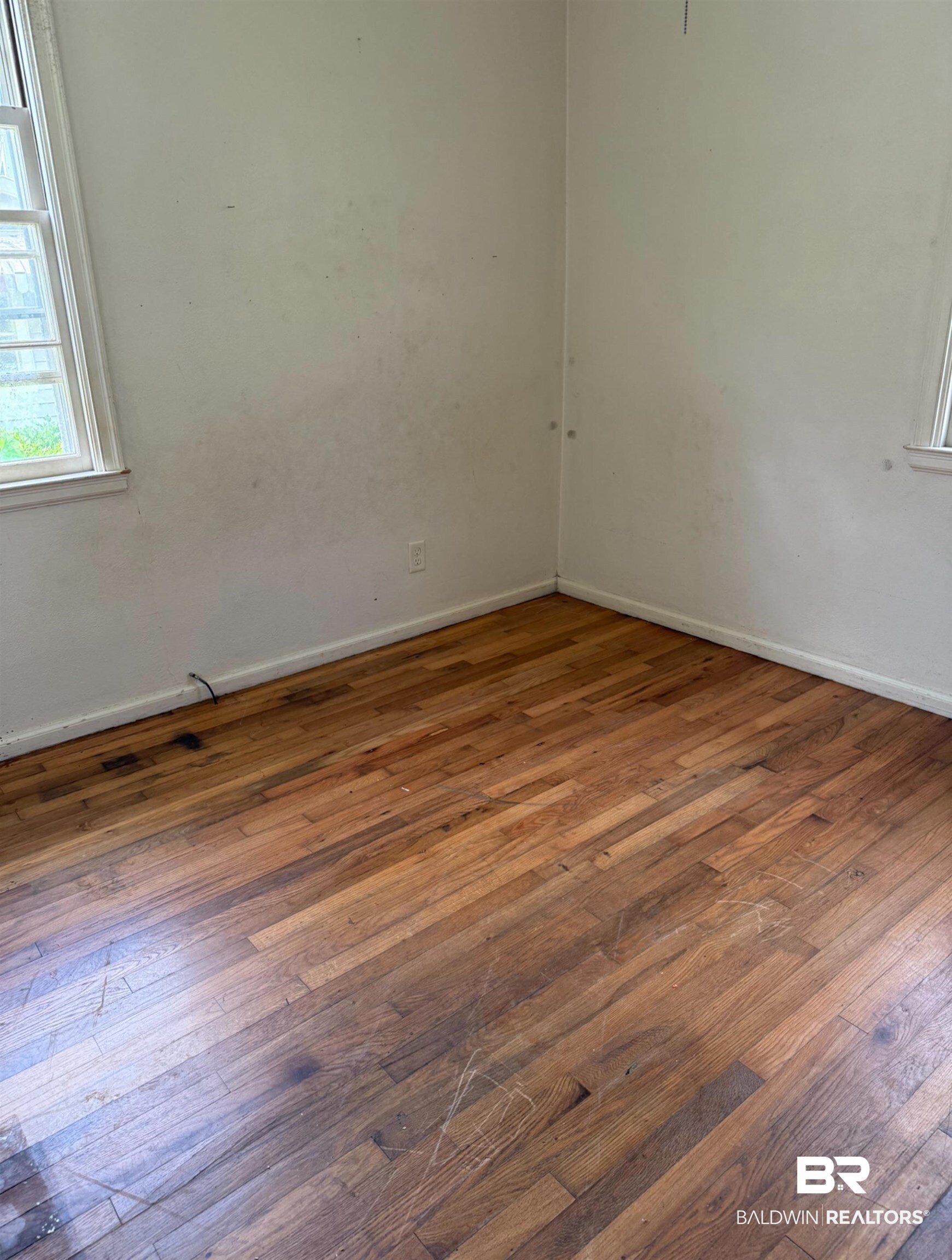 502 East Myrtle Avenue Foley, AL 36535 - Photo 8 of 9 Empty room with wood-type flooring and baseboards