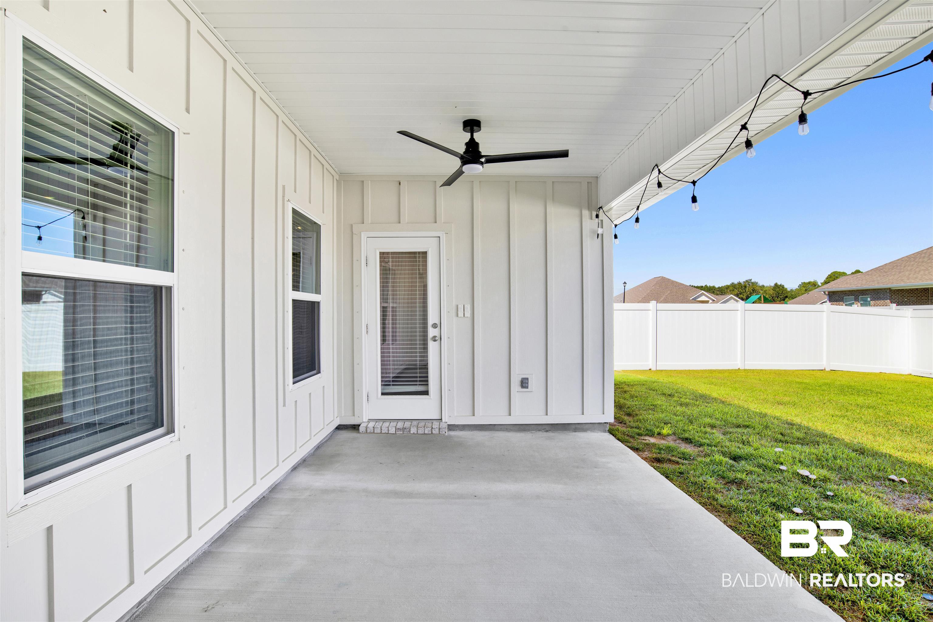 11602 Genuine Risk Circle Daphne, AL 36526 - Photo 25 of 30 Back patio with board and batten siding, a ceiling fan, and a patio