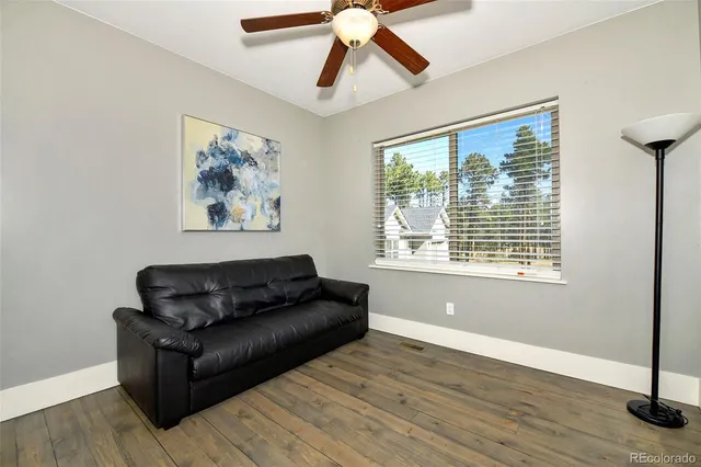 a living room with couch and a large window