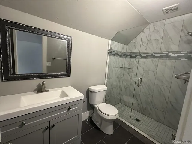a bathroom with a toilet a sink and shower