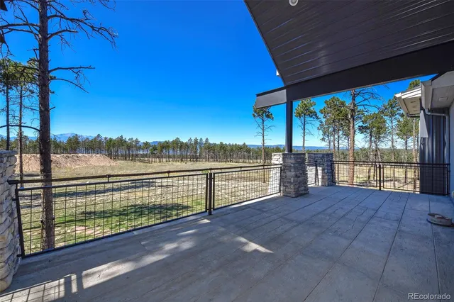 a view of balcony with floor to ceiling windows with wooden floor