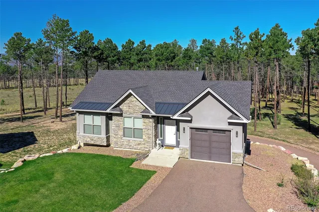 a house with green field in front of it
