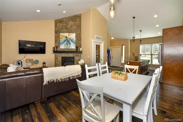 a view of a dining room with furniture a kitchen and chandelier