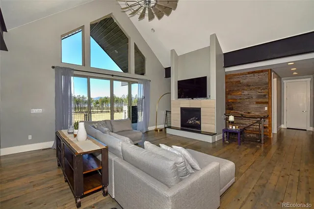 a living room with furniture fireplace and flat screen tv