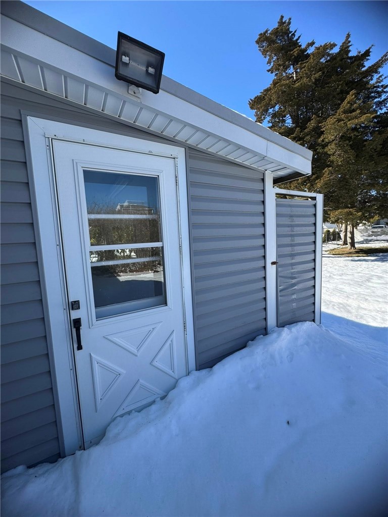 46 Salt Pond Way Westerly, RI 02891 - Photo 7 of 26 Door to the enclosed porch off of the garage and the outside shower stall