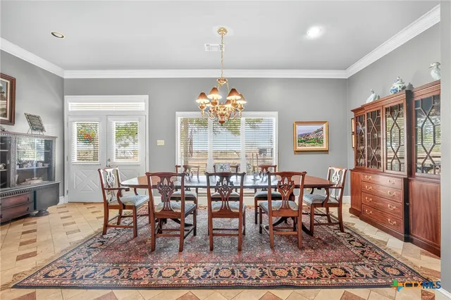 a living room with furniture a fireplace and a large window