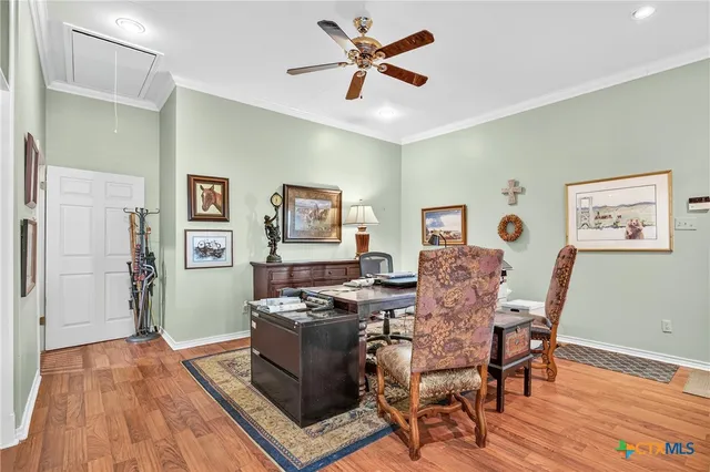 a view of a workspace with furniture and a window