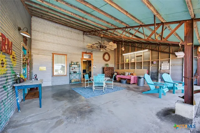 a view of a chairs and table in a patio