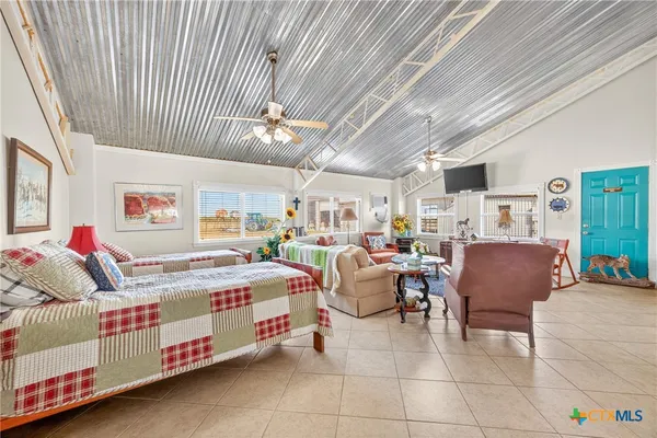 a living room with lots of furniture and a chandelier