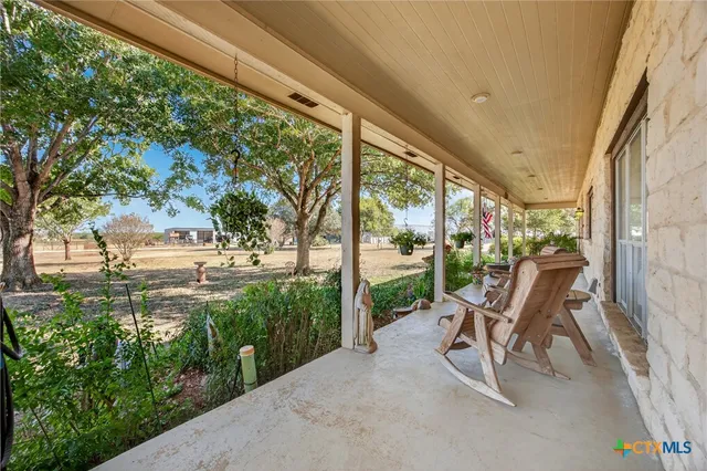 a view of a patio with chairs and table in patio