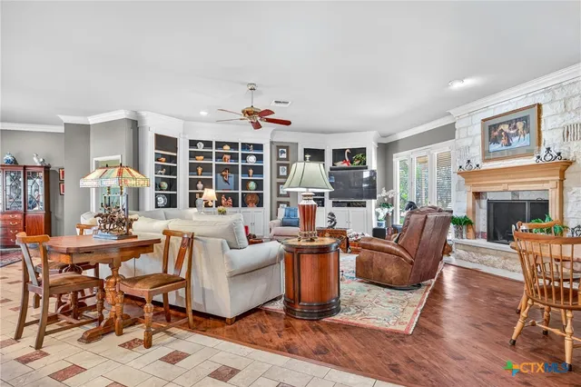 a living room with fireplace furniture and a wooden floor