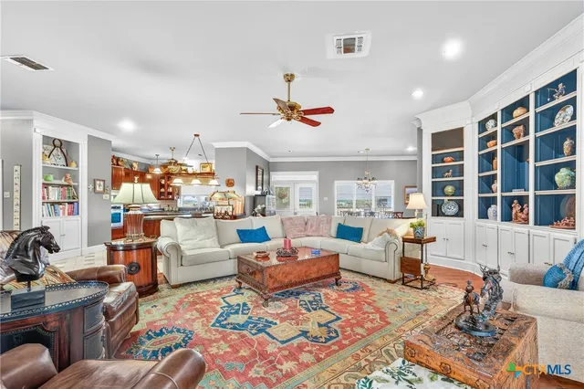 a living room with furniture fireplace and a large window