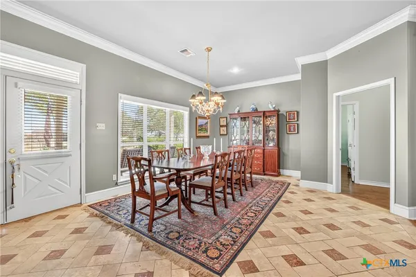 a dining room with furniture a rug and wooden floor