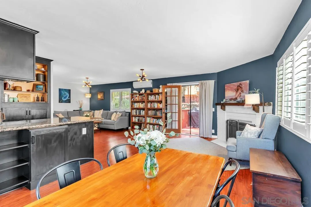 1635 Portola Avenue Spring Valley, CA 91977 - Photo 13 of 54 a dining room with furniture a wooden floor and a fireplace