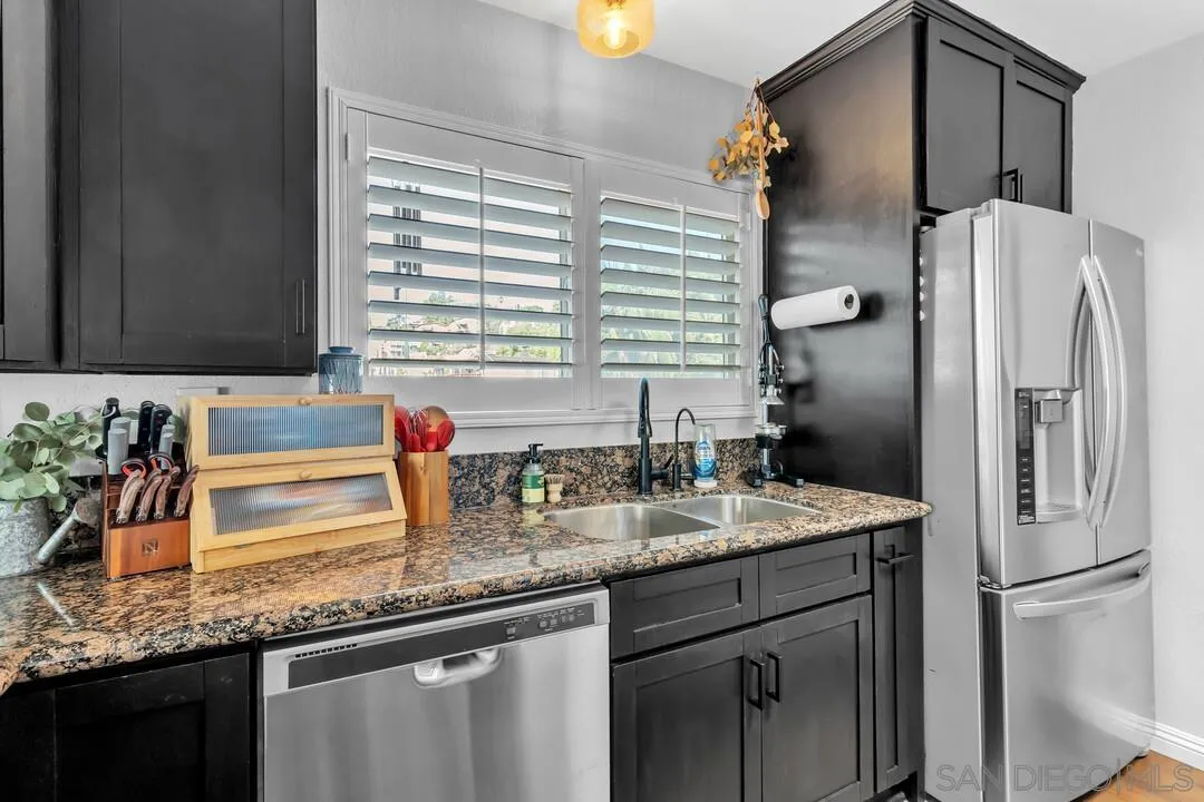 1635 Portola Avenue Spring Valley, CA 91977 - Photo 17 of 54 a kitchen with stainless steel appliances granite countertop a sink and a refrigerator