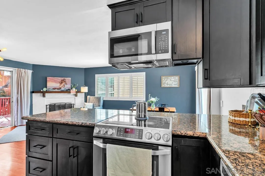 1635 Portola Avenue Spring Valley, CA 91977 - Photo 18 of 54 a kitchen with stainless steel appliances granite countertop a stove and a microwave