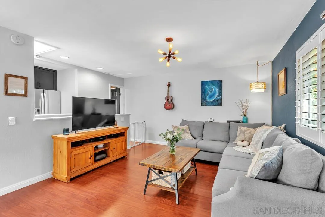 1635 Portola Avenue Spring Valley, CA 91977 - Photo 19 of 54 a living room with furniture a flat screen tv and a window