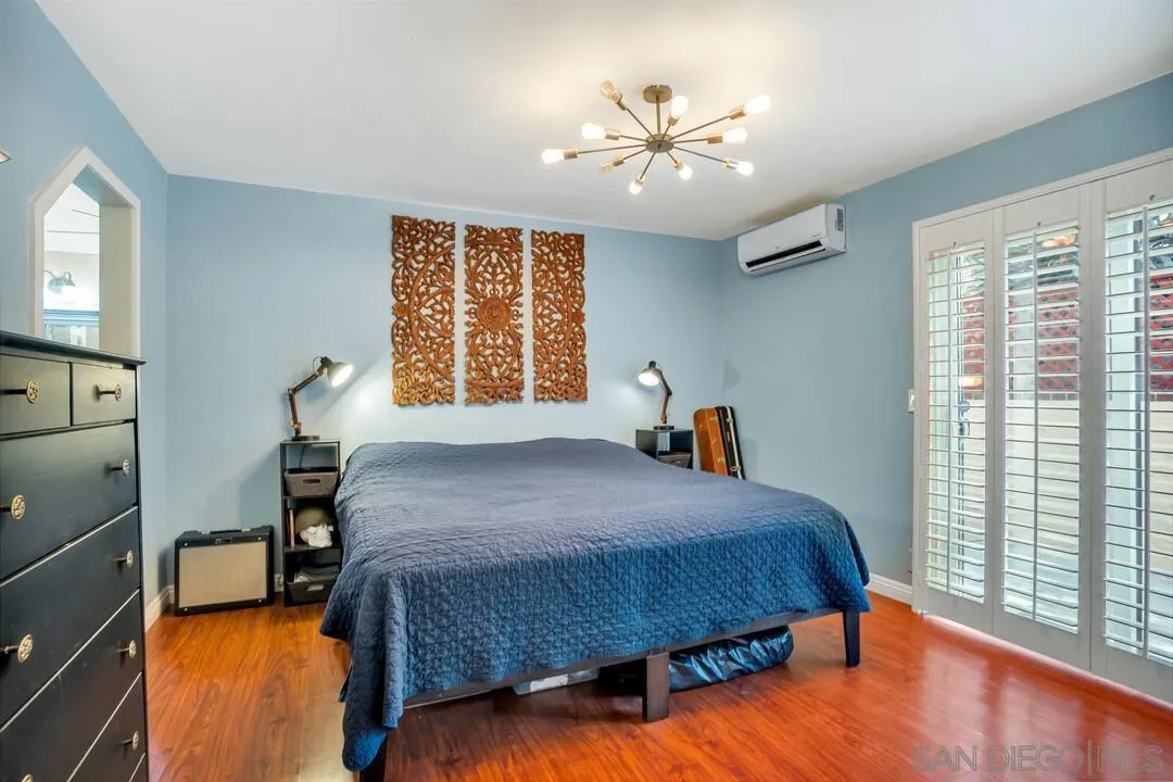 1635 Portola Avenue Spring Valley, CA 91977 - Photo 24 of 54 a bedroom with a large bed and a chandelier